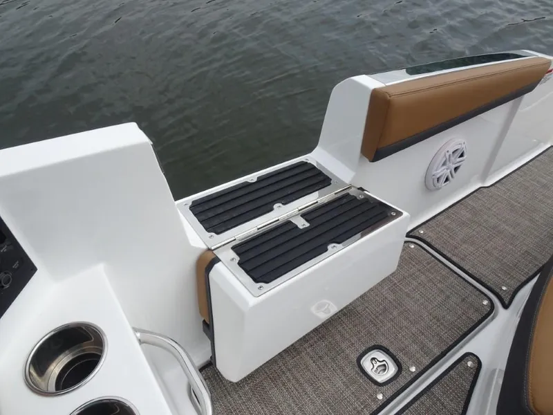 Slide: The Image of 2025 Cobalt R31 boat interior with cushioned seating, cup holders, and water-resistant flooring. - 11