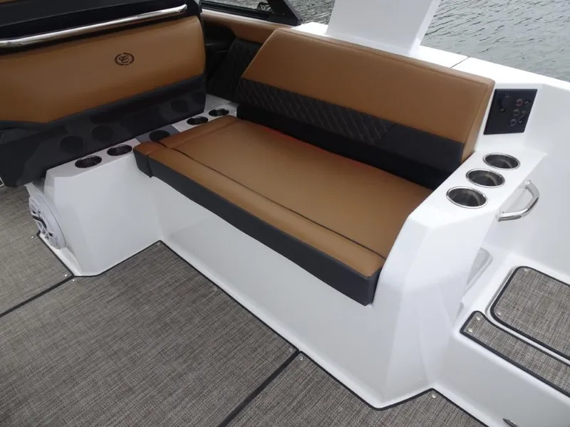 Slide: The Image of 2025 Cobalt R31 boat interior with brown seating and cup holders. - 12