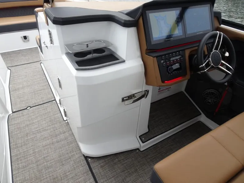 Slide: The Image of 2025 Cobalt R31 boat interior with modern dashboard, dual screens, and sleek steering wheel. - 19