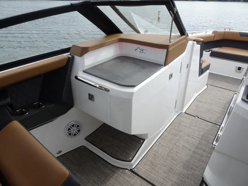 Slide: The Image of 2025 Cobalt R31 boat interior with sleek seating, modern design, and lake view. - 21