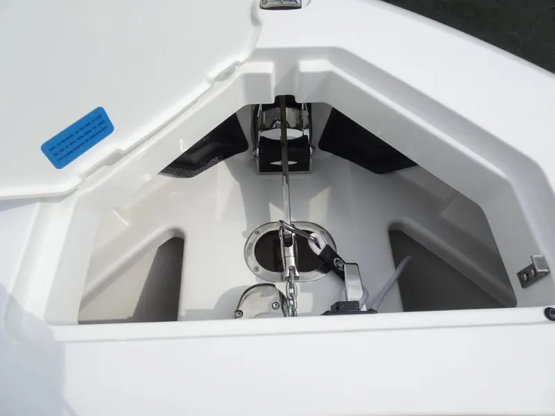 Slide: The Image of Anchor compartment of 2025 Cobalt R31 boat, featuring a neatly arranged anchor chain. - 25