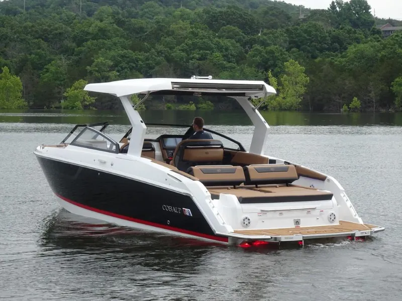 Slide: The Image of 2025 Cobalt R31 boat on a lake, featuring sleek design and spacious seating. - 3