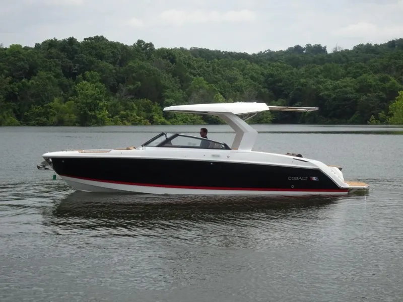 Slide: The Image of 2025 Cobalt R31 boat on a calm lake with lush green forest background. - 5