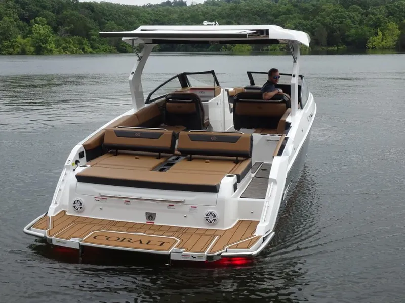 Slide: The Image of 2025 Cobalt R31 boat on a lake, featuring sleek design and spacious seating. - 7