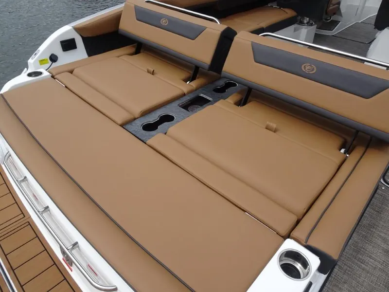 Slide: The Image of 2025 Cobalt R31 boat with tan leather seating and integrated cup holders. - 9