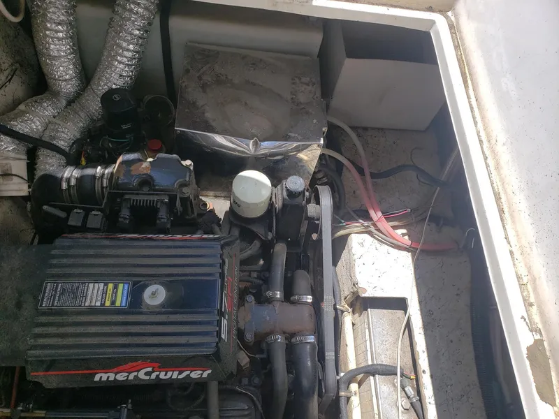 Slide: The Image of Engine compartment of a 1999 Rinker Fiesta Vee boat with MerCruiser components. - 13