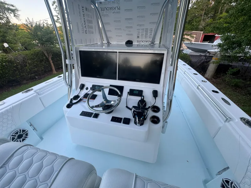 Slide: The Image of 2025 Contender 39ST boat console with dual screens and steering wheel. - 9