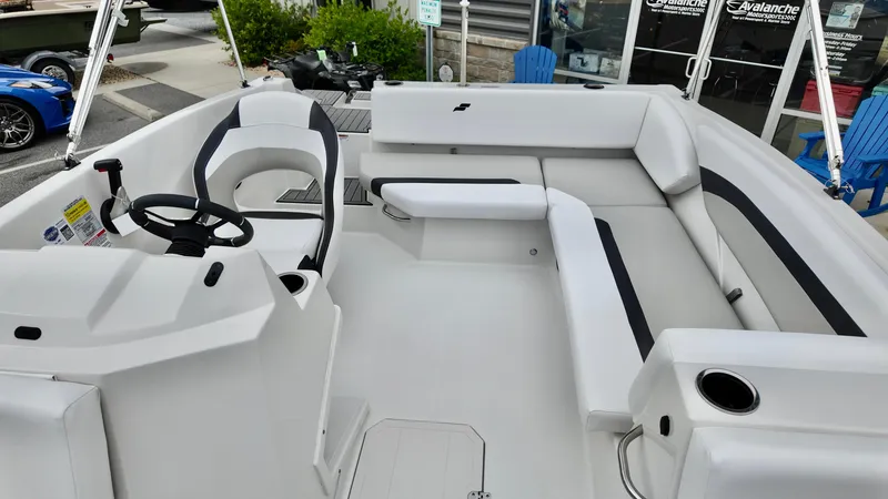 Slide: The Image of 2025 Starcraft SVX 171 OB boat interior with white seating and steering console. - 10