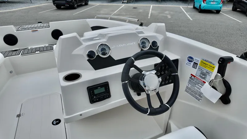 Slide: The Image of 2025 Starcraft SVX 171 OB boat dashboard with steering wheel and control panel. - 7