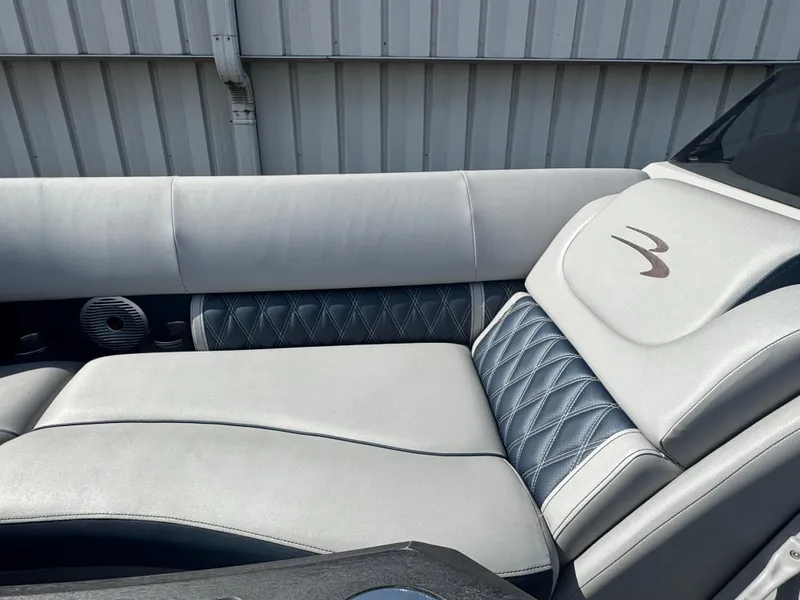 Slide: The Image of 2023 Bennington 24 LXFB pontoon boat interior with luxurious seating and modern helm. - 10