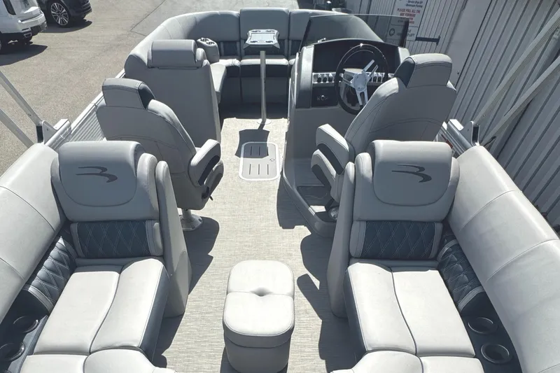 Slide: The Image of 2023 Bennington 24 LXFB boat interior with plush seating and table. - 12