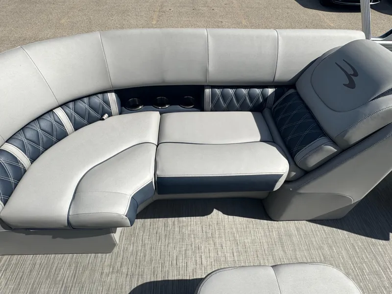 Slide: The Image of 2023 Bennington 24 LXFB boat cockpit with luxurious captain's chair and modern dashboard controls. - 14