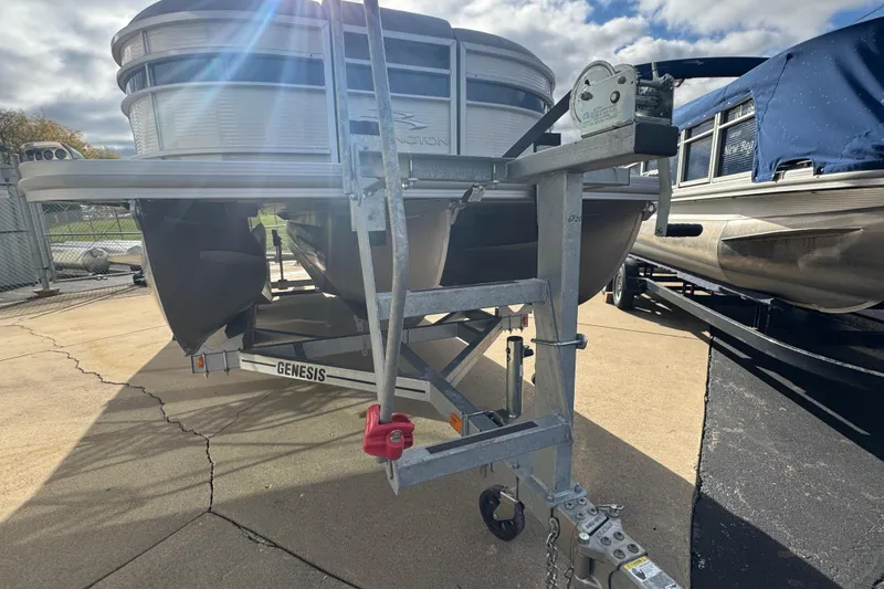 Slide: The Image of 2023 Bennington 24 LXFB pontoon boat on trailer under cloudy sky. - 29