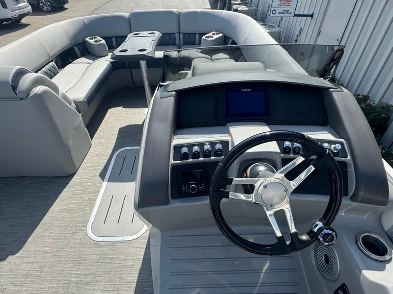 Slide: The Image of 2023 Bennington 24 LXFB pontoon boat on trailer under cloudy sky. - 5