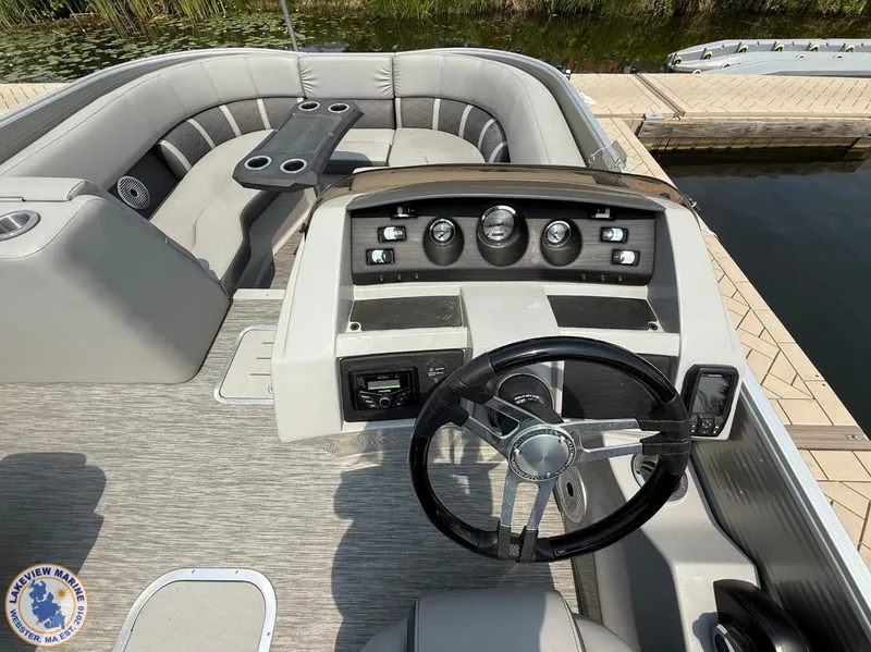 Slide: The Image of 2021 Bennington 23 LTFB boat interior with steering wheel and seating area. - 5