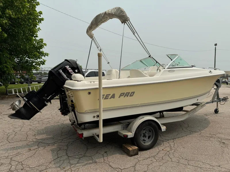 Slide: The Image of 2007 Sea Pro 186 Dual Console boat on trailer with outboard motor, parked outdoors. - 4