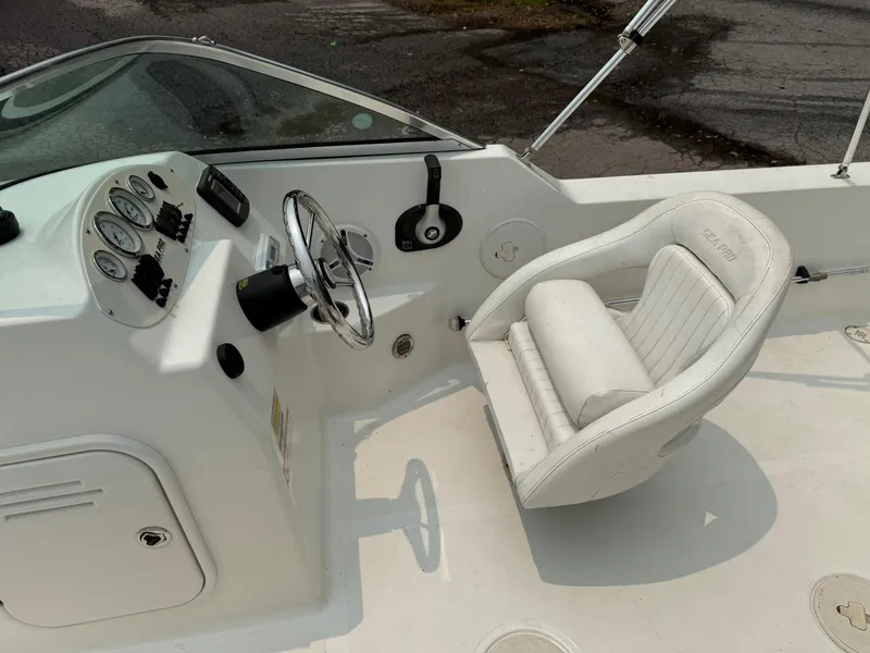 Slide: The Image of 2007 Sea Pro 186 Dual Console boat interior with steering wheel and white captain's chair. - 7