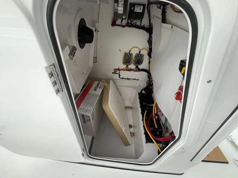 Slide: The Image of 2025 Sportsman Open 232 Center Console interior wiring and storage compartment. - 10