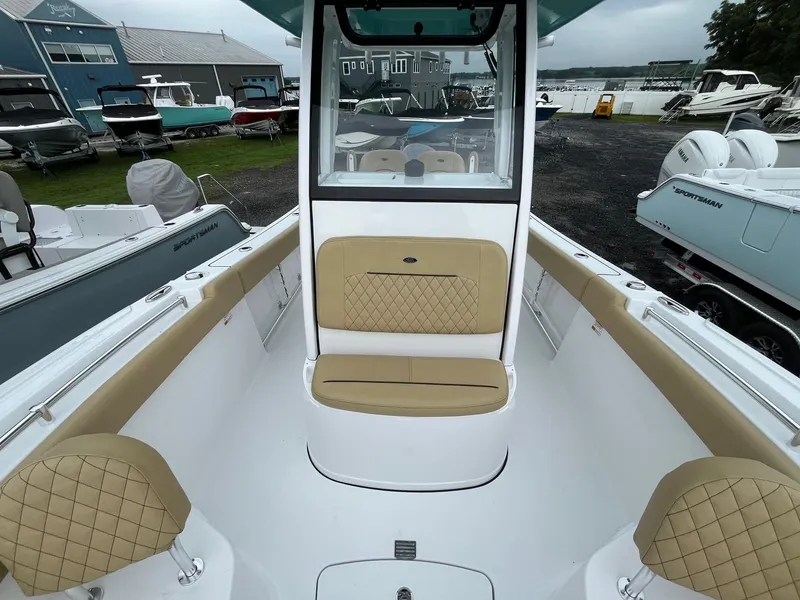 Slide: The Image of 2025 Sportsman Open 232 Center Console boat with tan seating and modern design. - 11