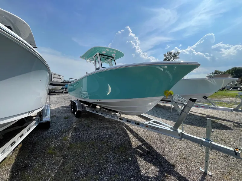 Slide: The Image of 2025 Sportsman Open 232 Center Console boat on trailer under blue sky. - 3