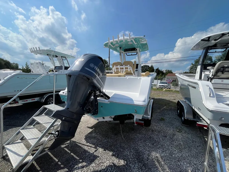 Slide: The Image of 2025 Sportsman Open 232 Center Console boat with Yamaha engine, displayed outdoors. - 4