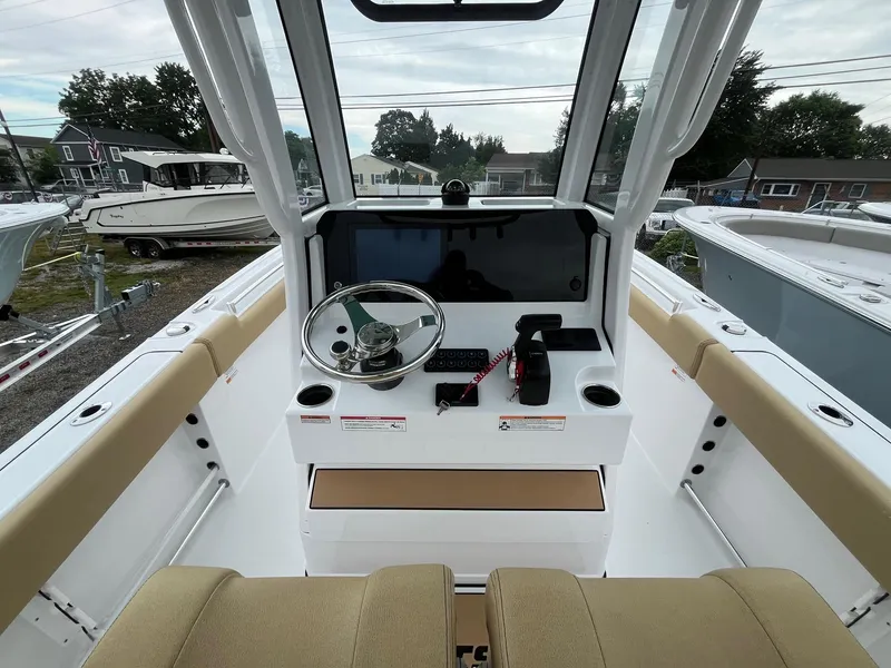 Slide: The Image of 2025 Sportsman Open 232 Center Console boat interior with steering wheel and control panel. - 9