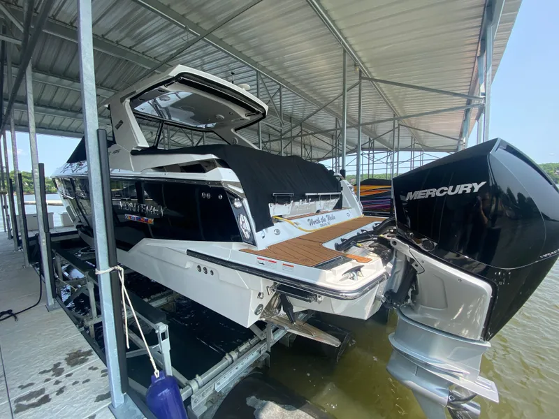 Slide: The Image of 2022 Monterey 385 Super Sport boat docked with Mercury outboard engine. - 11