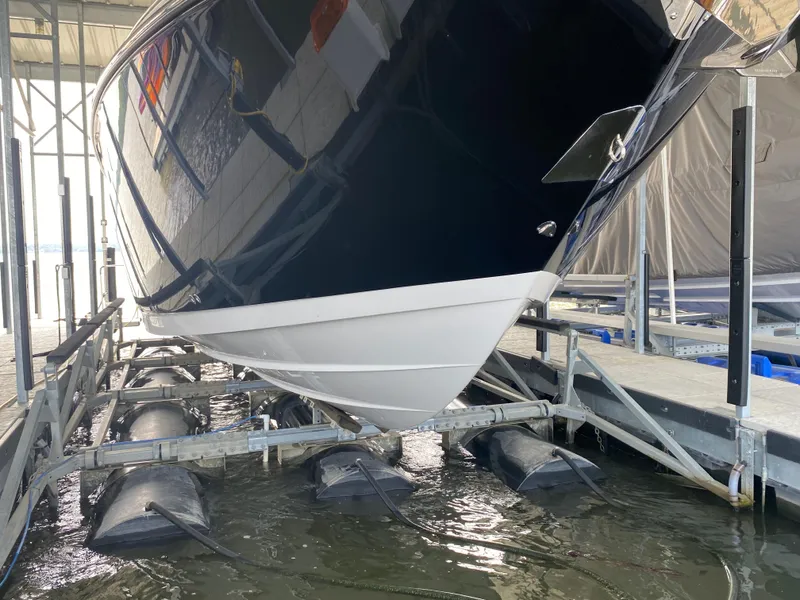Slide: The Image of 2022 Monterey 385 Super Sport boat on lift in marina. - 12