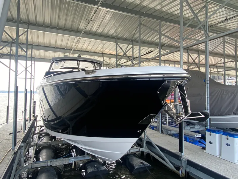 Slide: The Image of 2022 Monterey 385 Super Sport boat docked in a covered marina. - 13