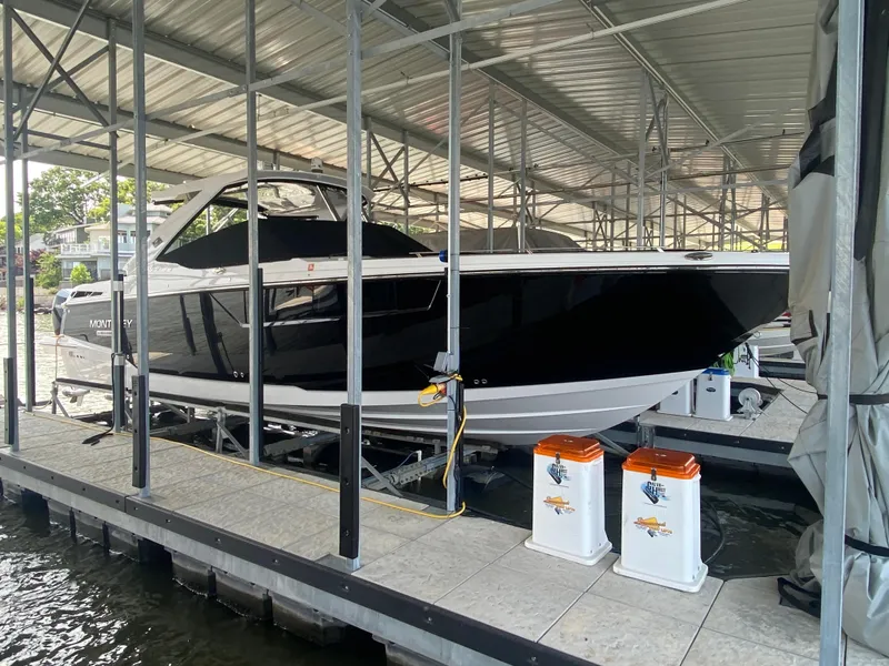 Slide: The Image of 2022 Monterey 385 Super Sport boat docked in a covered marina. - 14