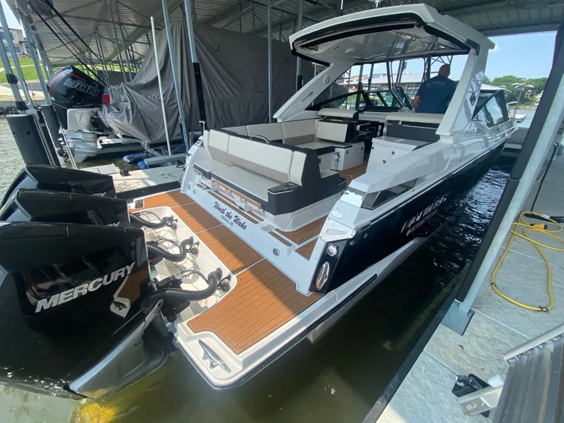 Slide: The Image of 2022 Monterey 385 Super Sport boat docked with Mercury engines. - 17