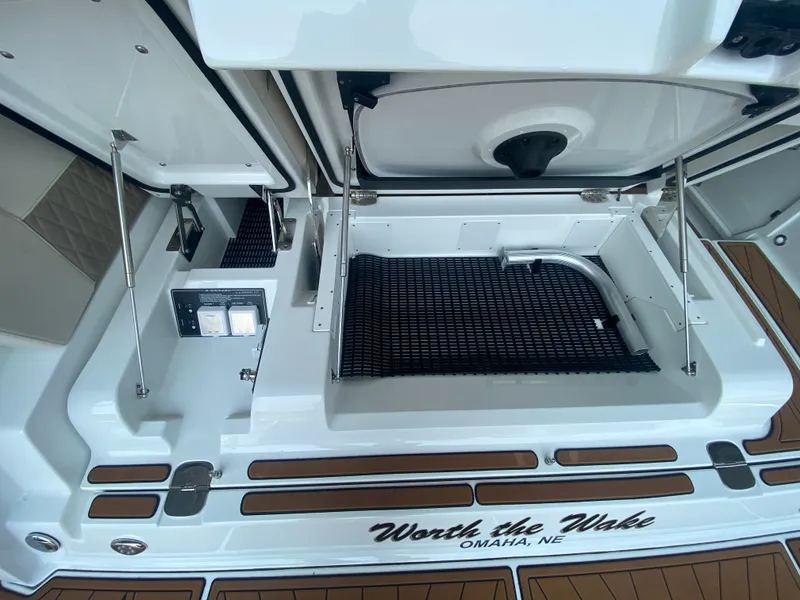 Slide: The Image of 2022 Monterey 385 Super Sport boat storage compartment, open hatch, "Worth the Wake" text visible. - 18