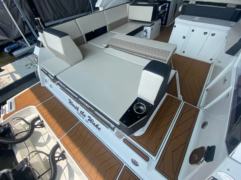 Slide: The Image of 2022 Monterey 385 Super Sport boat interior with luxurious seating and wood-style flooring. - 19
