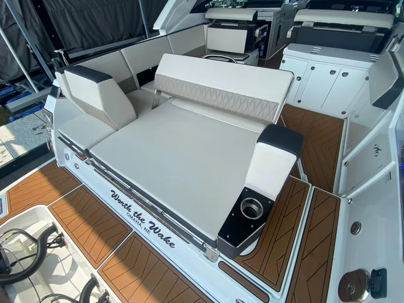 Slide: The Image of 2022 Monterey 385 Super Sport boat interior with luxurious seating and wood-style flooring. - 20