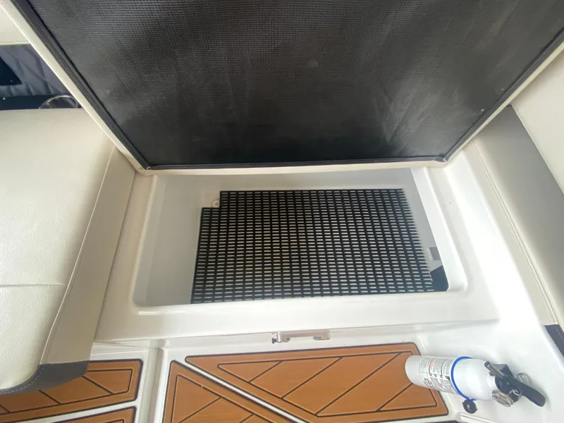 Slide: The Image of 2022 Monterey 385 Super Sport boat interior storage compartment with safety equipment. - 27