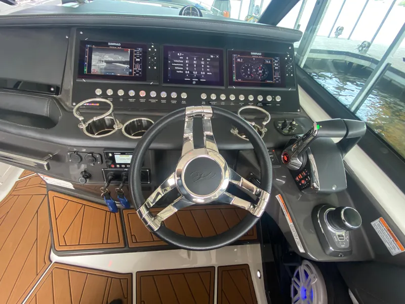 Slide: The Image of 2022 Monterey 385 Super Sport boat dashboard with modern controls and steering wheel. - 35