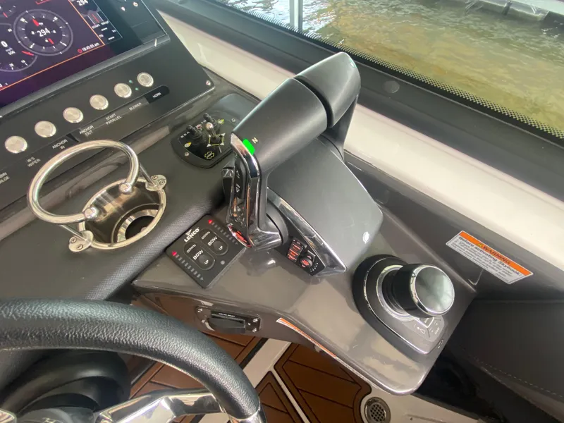Slide: The Image of Control panel of a 2022 Monterey 385 Super Sport boat with steering and throttle controls. - 36