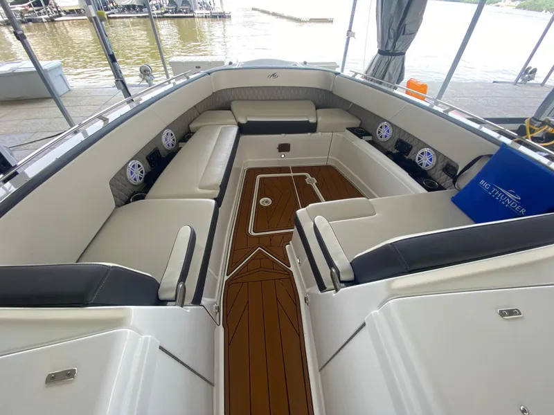 Slide: The Image of 2022 Monterey 385 Super Sport boat interior with luxurious seating and wood flooring. - 42
