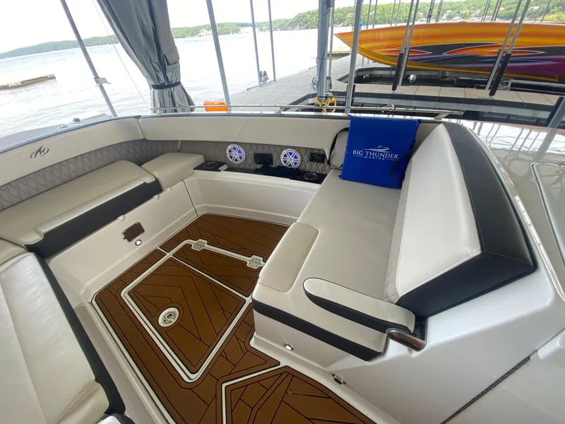 Slide: The Image of 2022 Monterey 385 Super Sport boat interior with luxurious seating and wood-patterned flooring. - 44