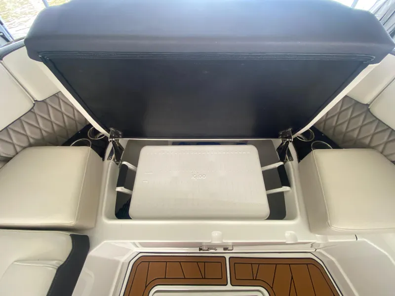 Slide: The Image of 2022 Monterey 385 Super Sport boat interior with open storage compartment and seating. - 47