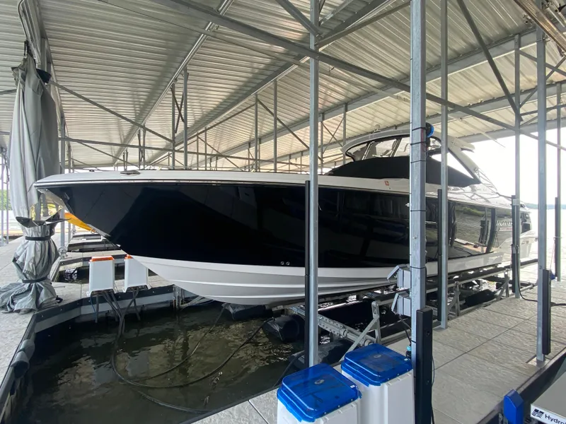 Slide: The Image of 2022 Monterey 385 Super Sport boat docked in a covered marina. - 8