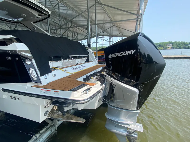 Slide: The Image of 2022 Monterey 385 Super Sport boat with Mercury engine docked in a marina. - 9