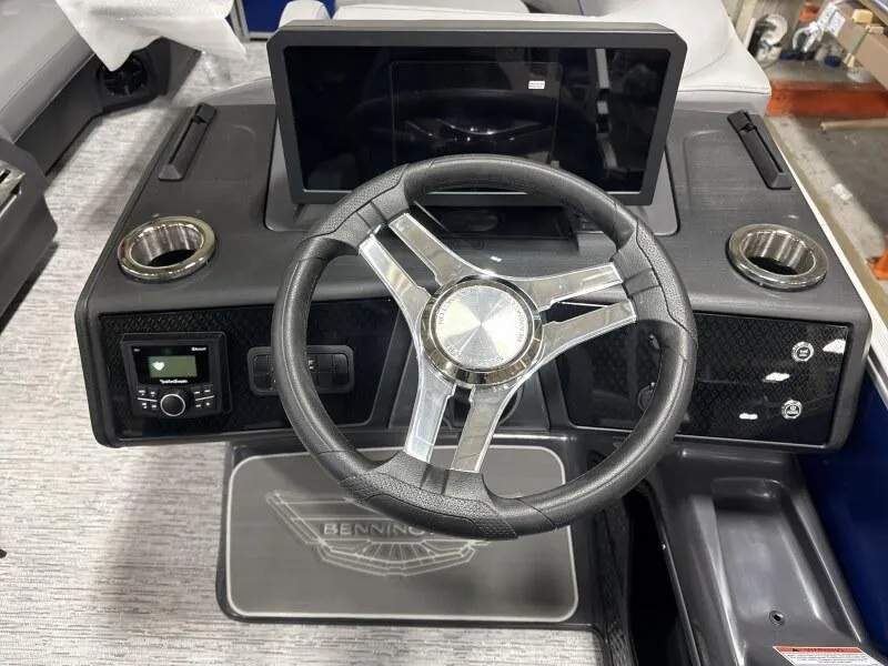 Slide: The Image of Steering console of 2025 Bennington 22 MFB boat with modern controls and cup holders. - 13