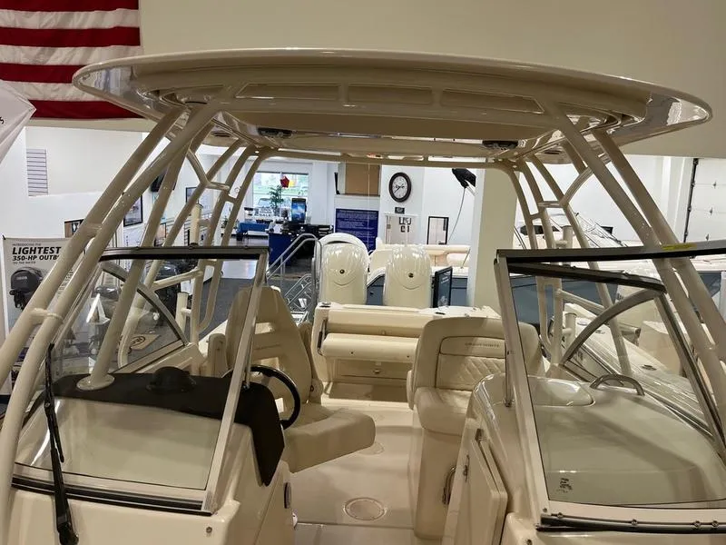 Slide: The Image of 2025 Grady-White Freedom 255 boat interior with seating and helm, displayed indoors. - 10