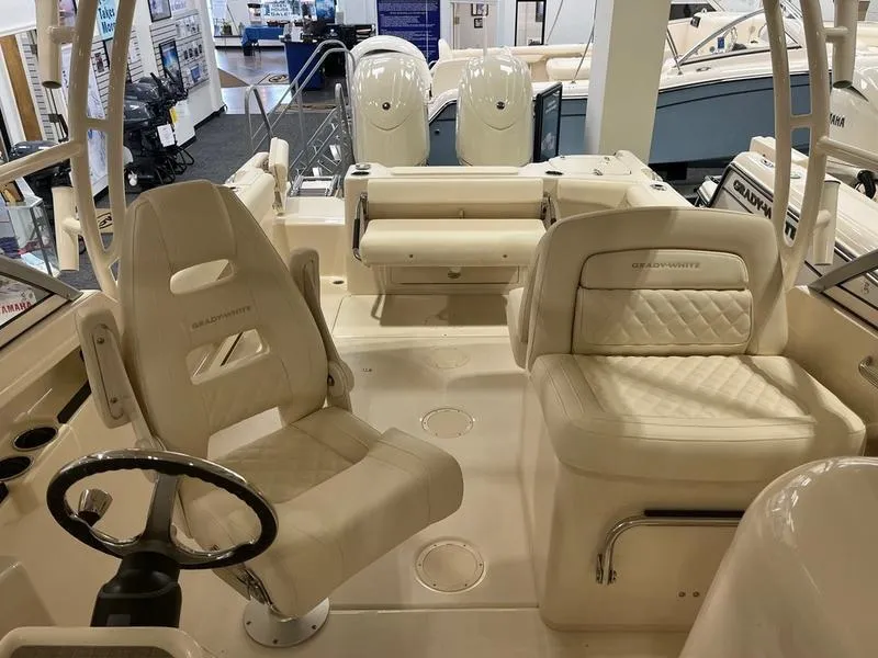 Slide: The Image of 2025 Grady-White Freedom 255 boat interior with seating and steering wheel. - 11