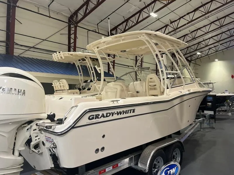 Slide: The Image of 2025 Grady-White Freedom 255 boat in showroom, featuring Yamaha engine and sleek design. - 3