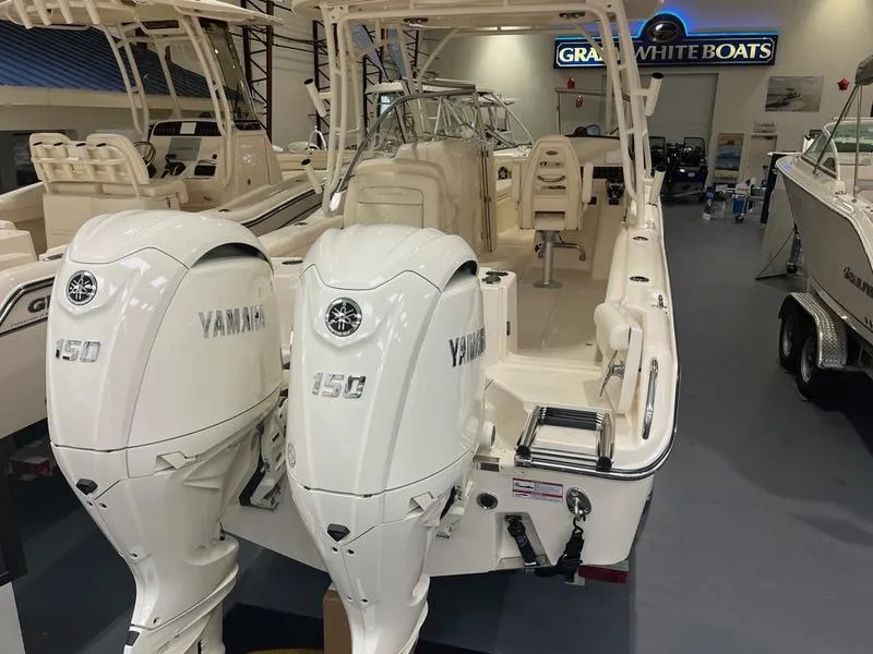 Slide: The Image of 2025 Grady-White Freedom 255 boat with twin Yamaha 150 engines in showroom. - 4