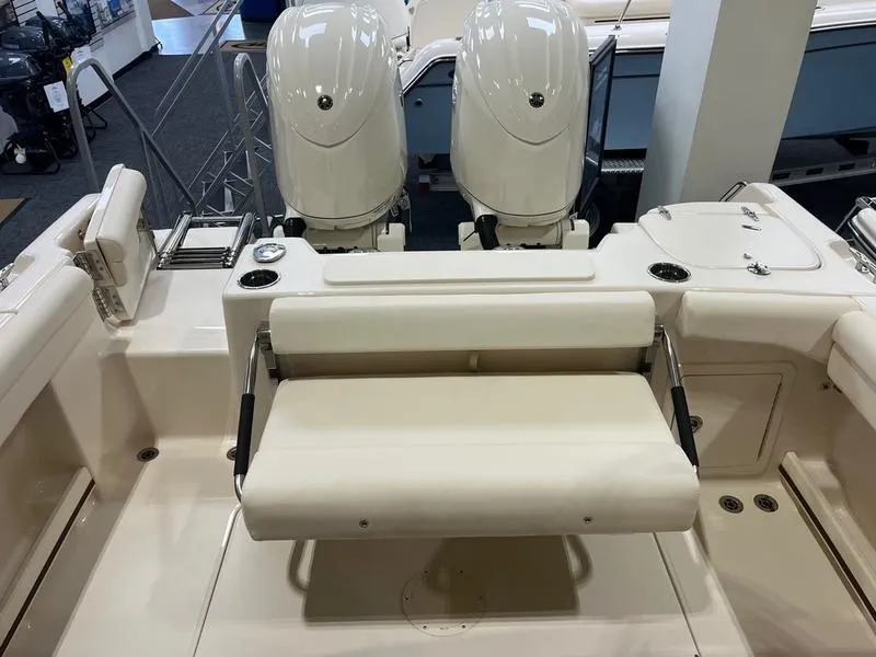 Slide: The Image of 2025 Grady-White Freedom 255 boat interior with dual engines and seating area. - 5
