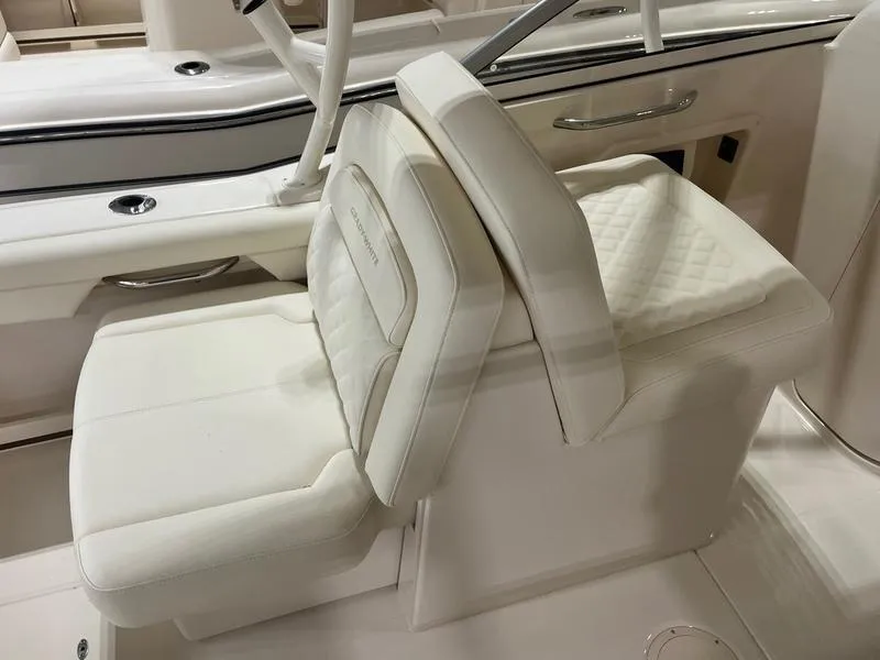Slide: The Image of 2025 Grady-White Freedom 255 boat interior with luxurious white seating and sleek design. - 6