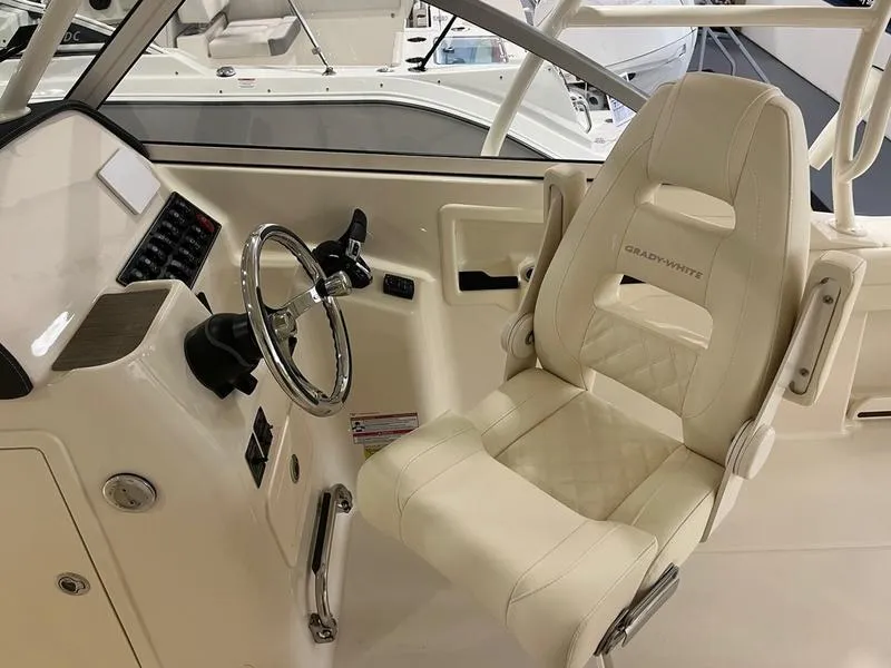 Slide: The Image of 2025 Grady-White Freedom 255 boat interior with steering wheel and captain's chair. - 7